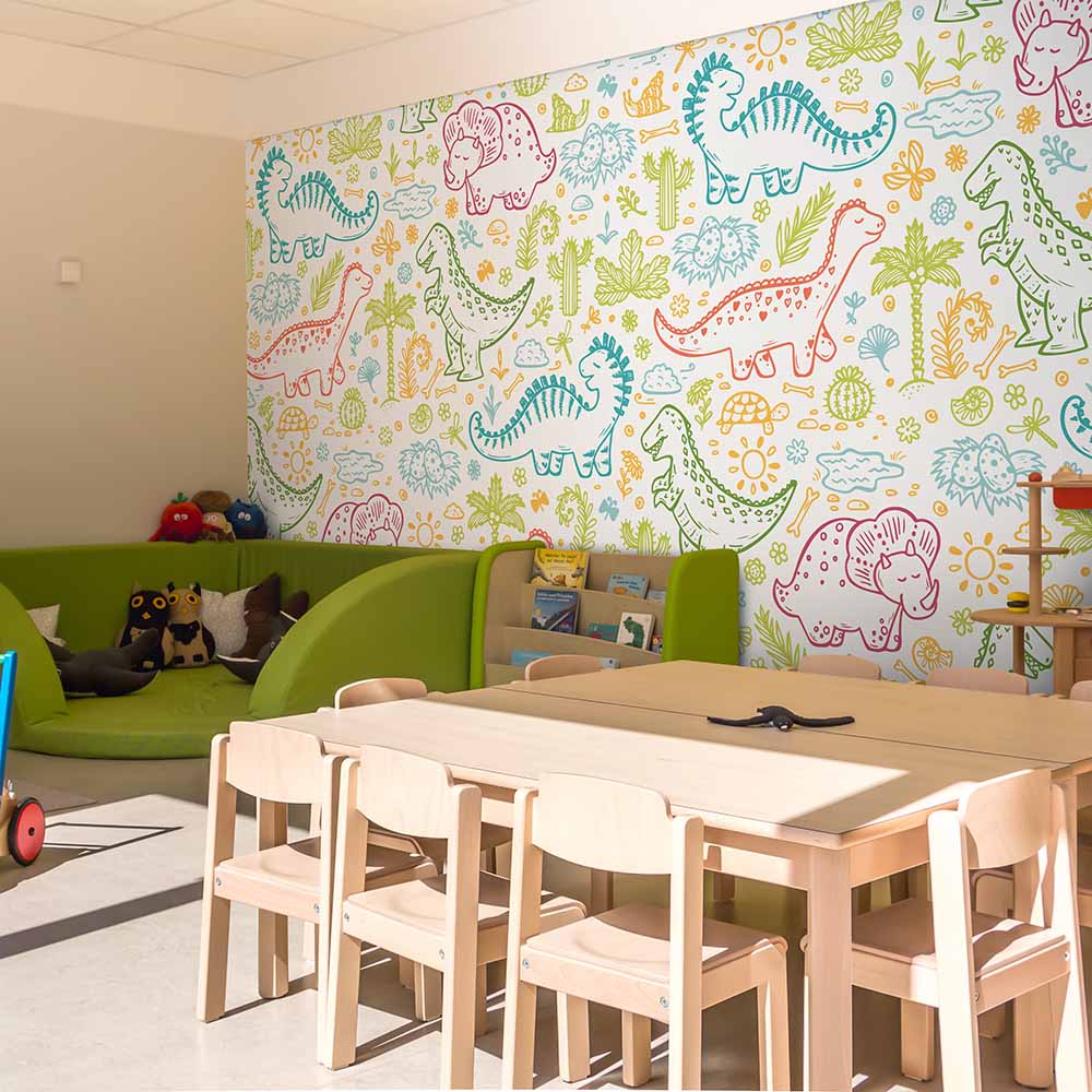 Playful dinosaur-themed wallpaper in a colorful kids' play area.