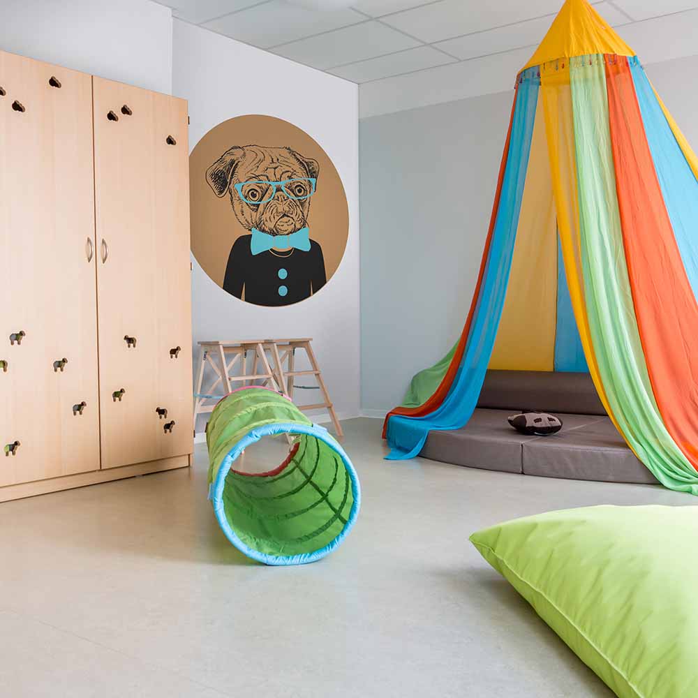 Cute pug in glasses wallpaper in a colorful kids' playroom.