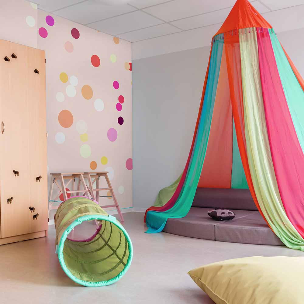 Colorful polka dot wallpaper adds a fun vibe to the playroom.