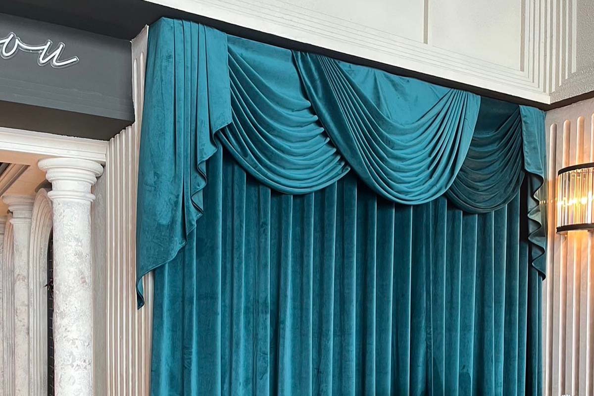 Beautiful Swag and tail style green velvet curtains.