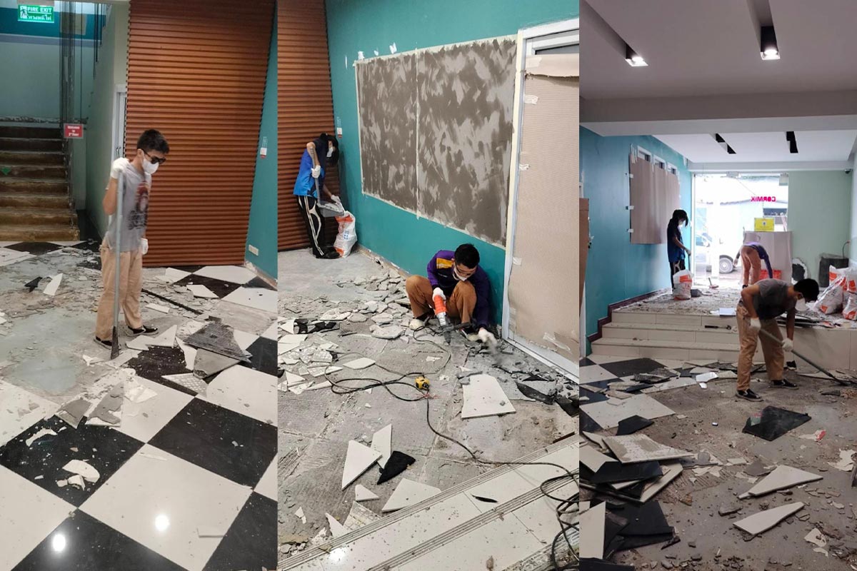 Old tile removal in progress at Cormix Bangkok office, showing the team dismantling and clearing damaged flooring.