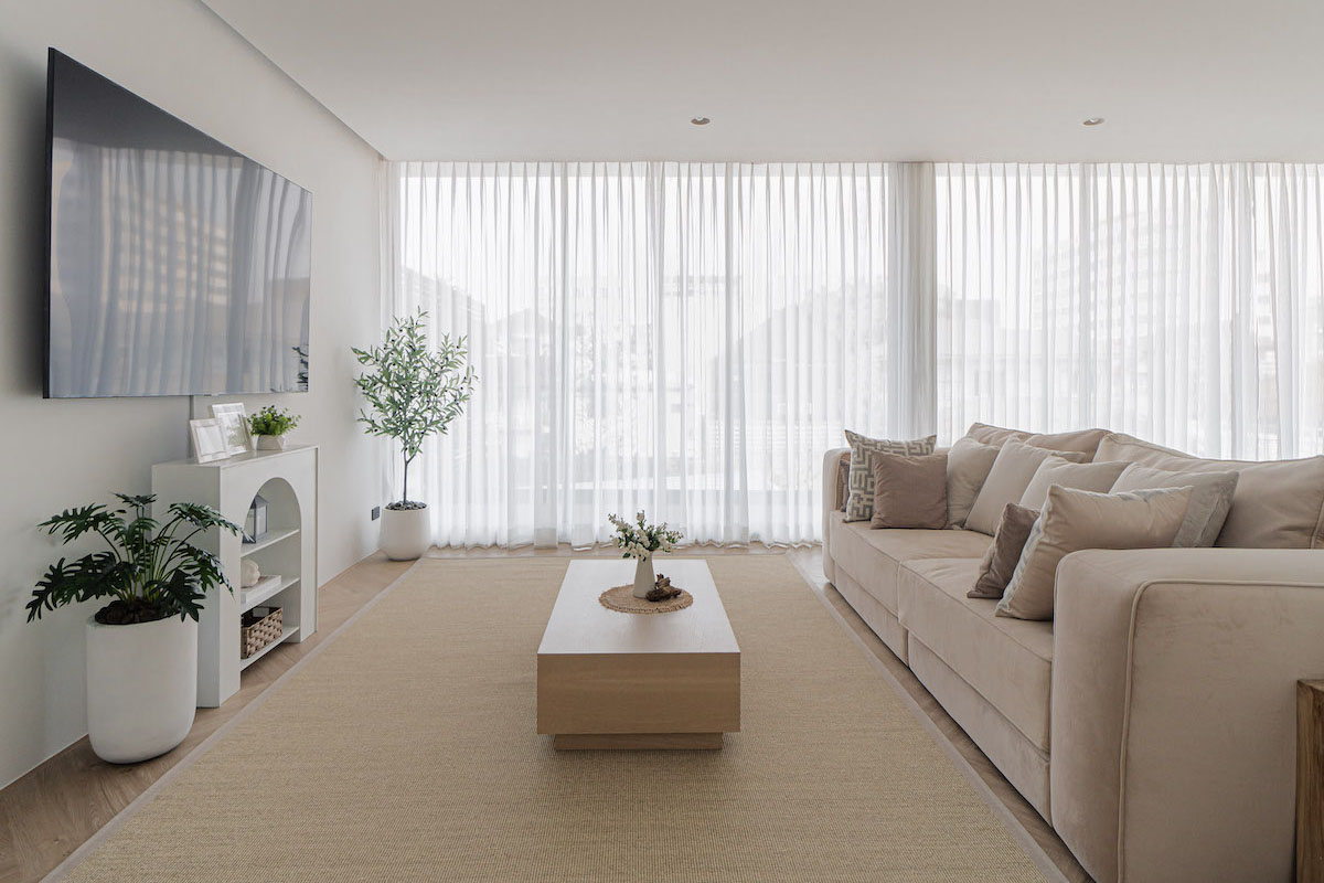 Living room adorned with sheer curtains.