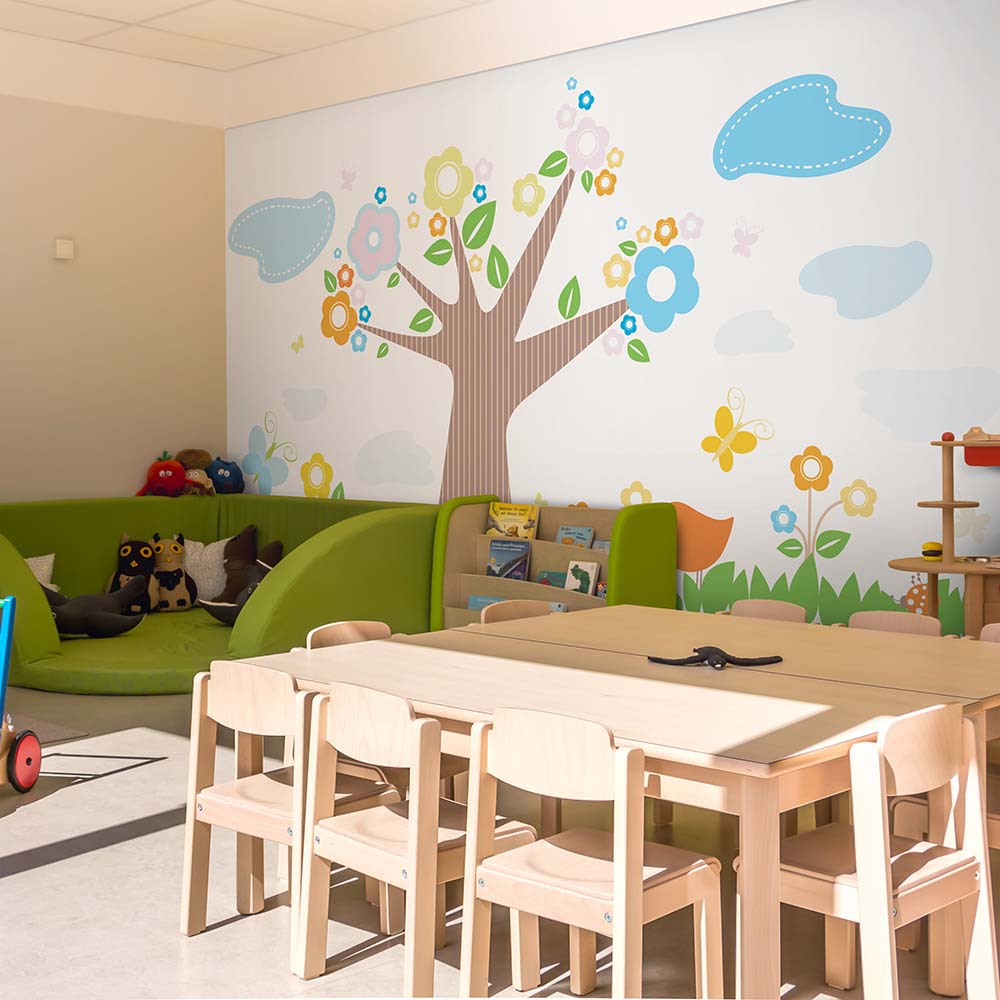 Tree and floral wallpaper in a kids' playroom.