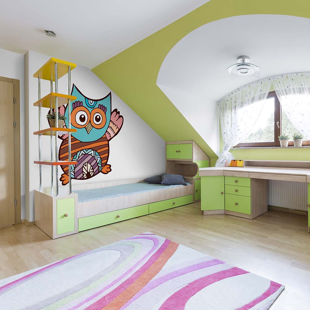 Colorful owl wallpaper in a bright kids' bedroom.
