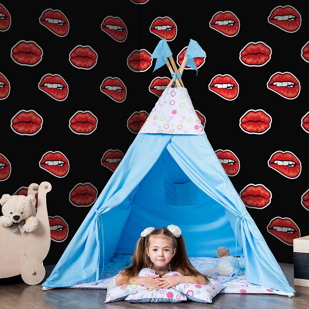 Bold lip-print wallpaper in a playful kids' playroom.