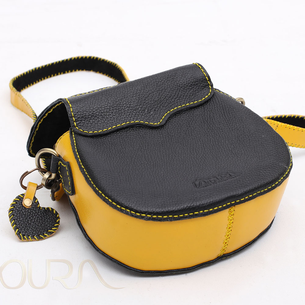 Black-and-yellow leather bag with heart charm.
