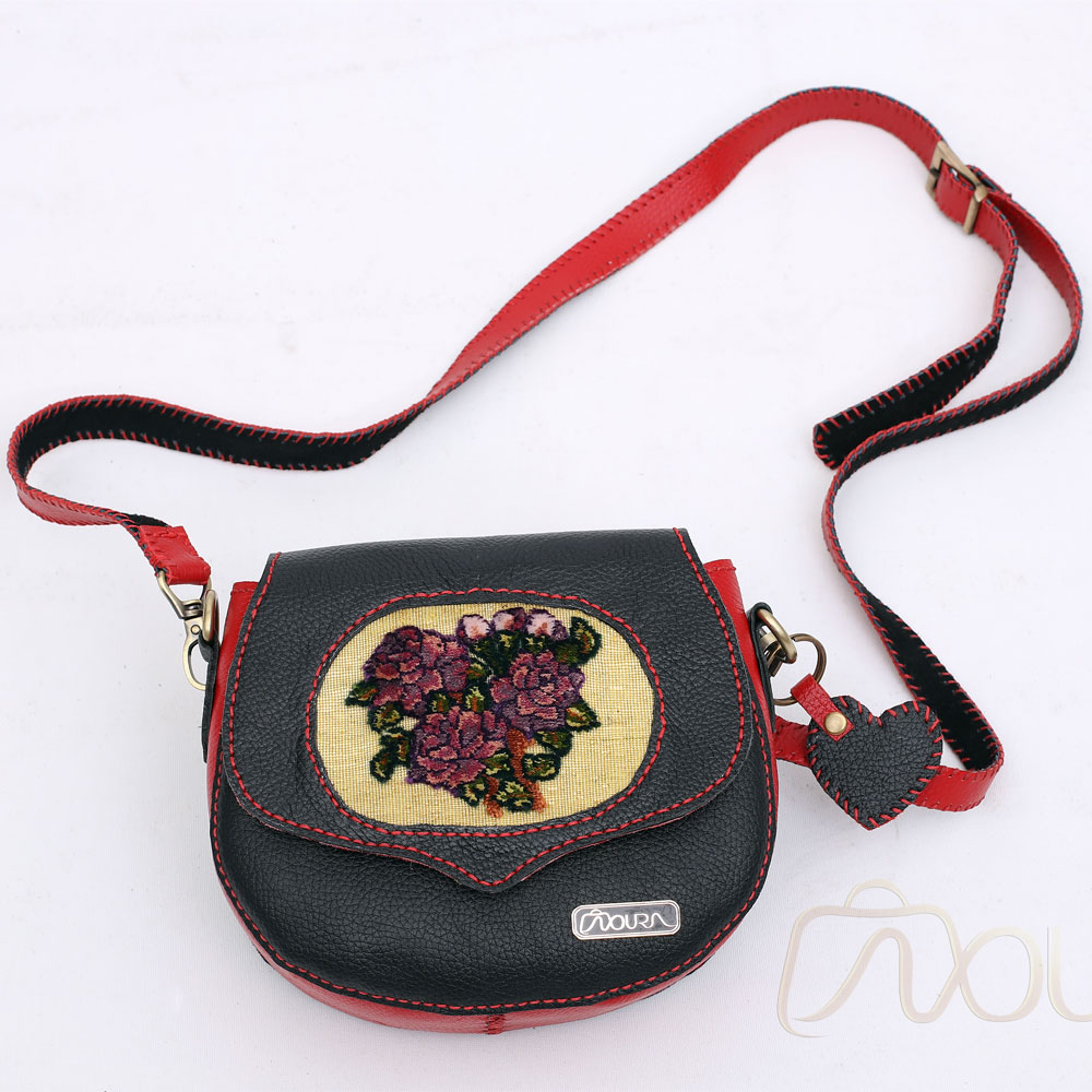 Black-and-red crossbody with floral woven front panel.