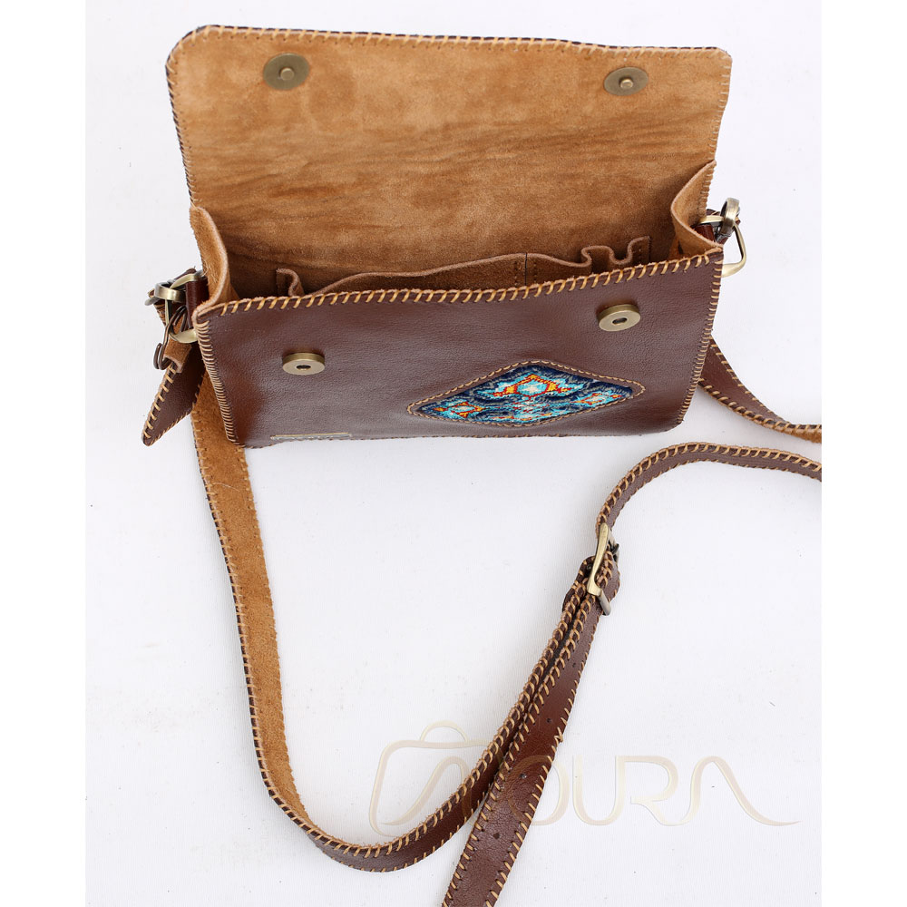 Open brown leather bag with diamond woven carpet.