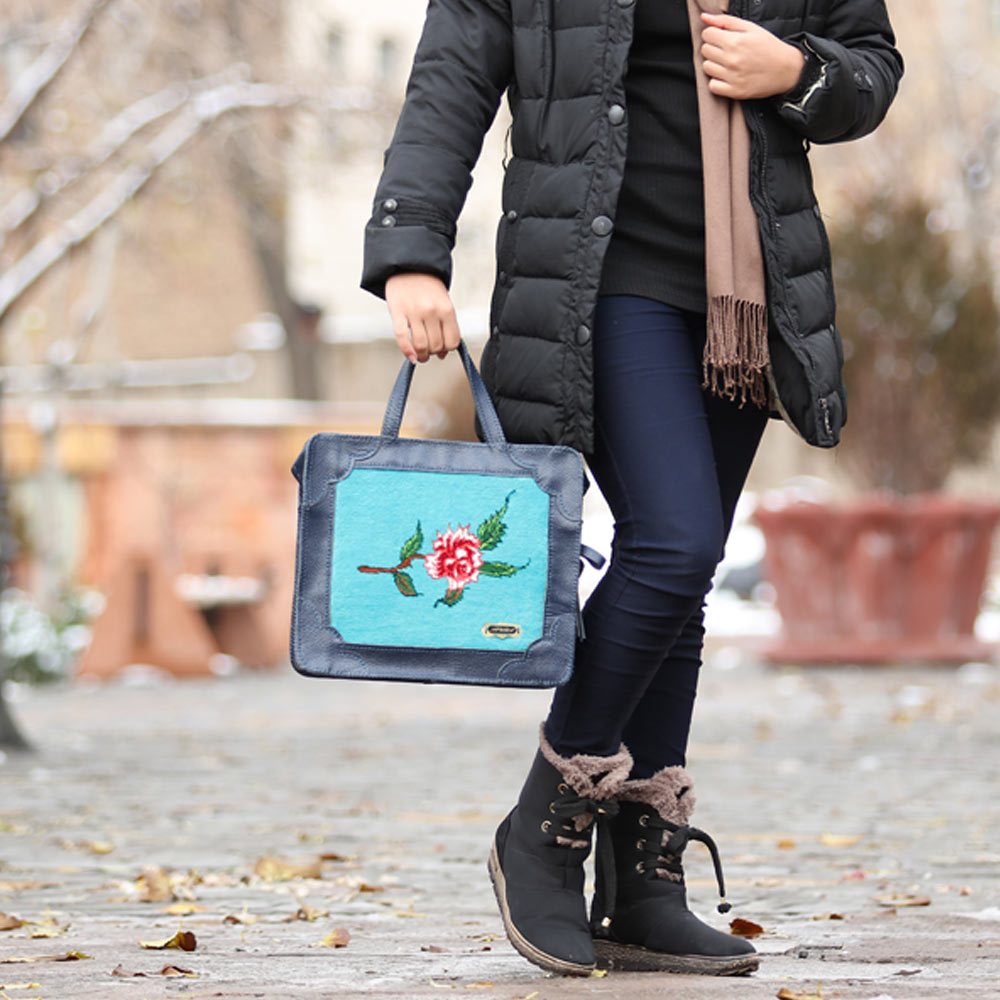Handmade blue leather women bag with carpet accent on it.