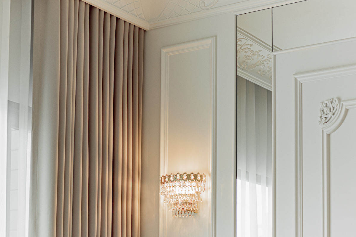 Classic Drapes and Crystal Wall Sconce in an Elegant Interior.