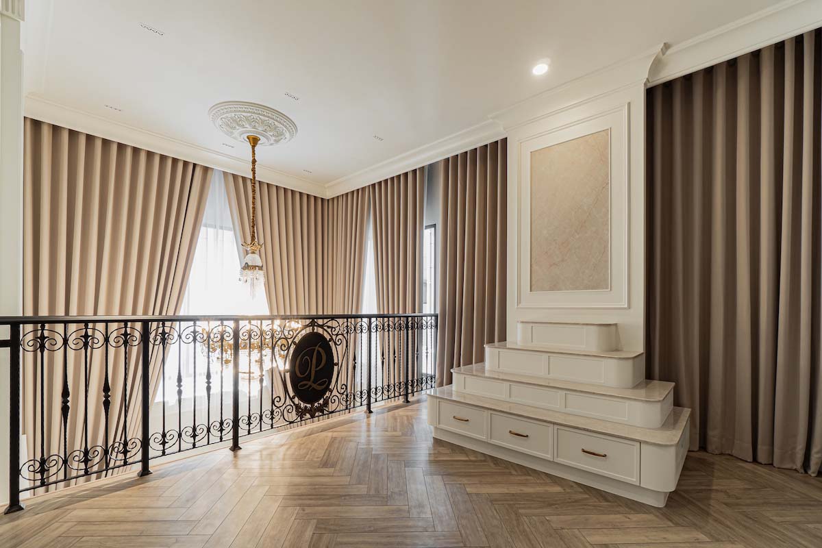 Architectural Harmony: Luxurious Drapery and Wrought-Iron Balustrade.